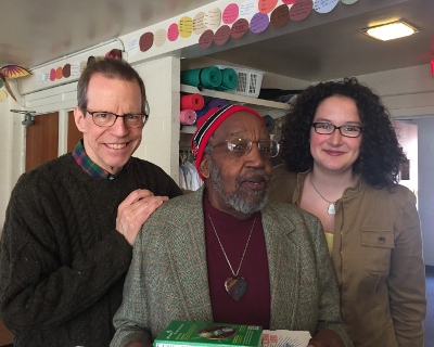 Three congregants smiling for a picture indoors